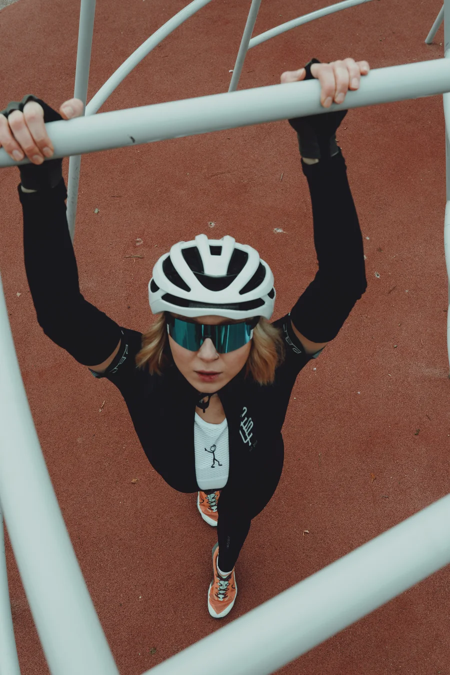 Portrait of a cyclist viewed from above through metal railings