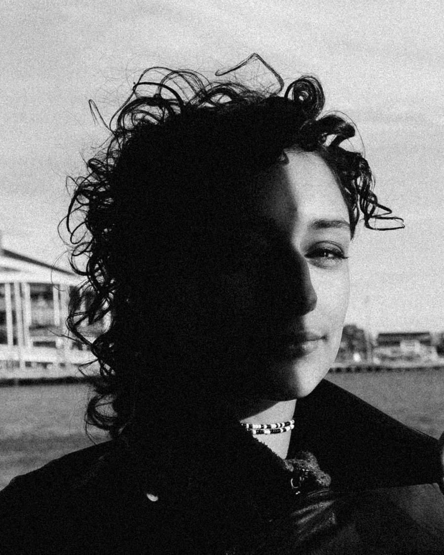 Black and white portrait of a woman with curly hair