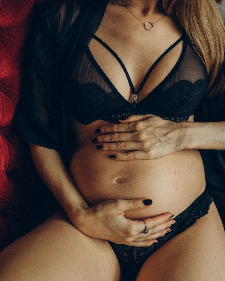 Maternity portrait with hands resting on a pregnant belly
